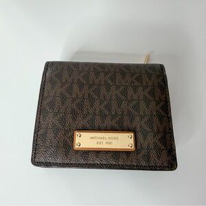 Michael Kors Dark Brown Signature MK Bifold Wallet with Gold Plaque.
